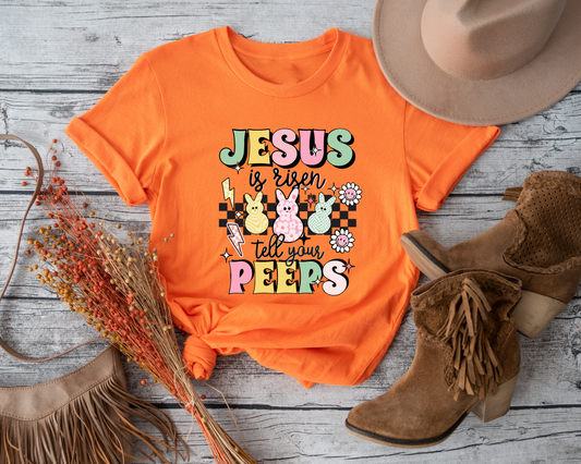 Celebrate the joyous Easter holiday with this adorable "Jesus is Risen Tell Your Peeps" toddler shirt.