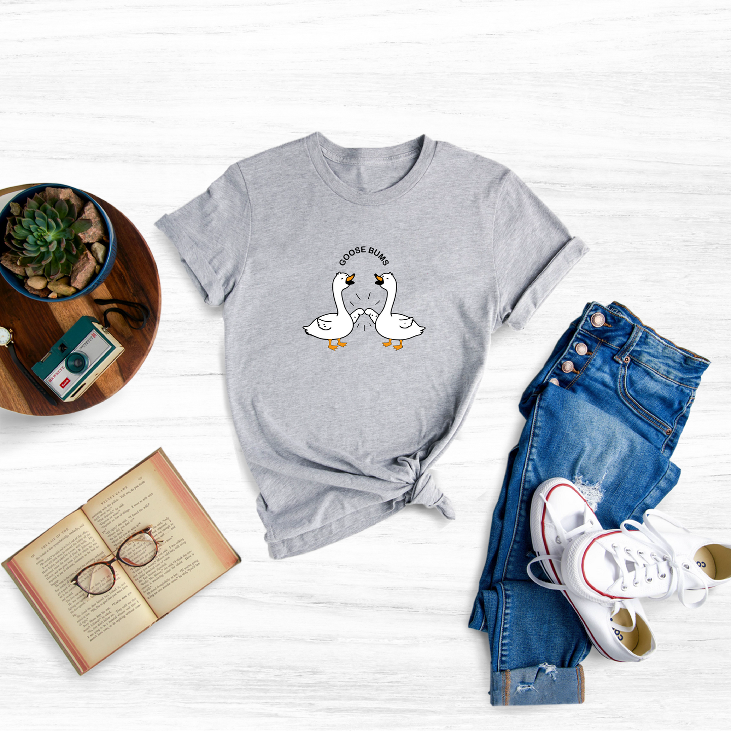 Celebrate the beauty and symbolism of geese with this charming embroidered goose tee.