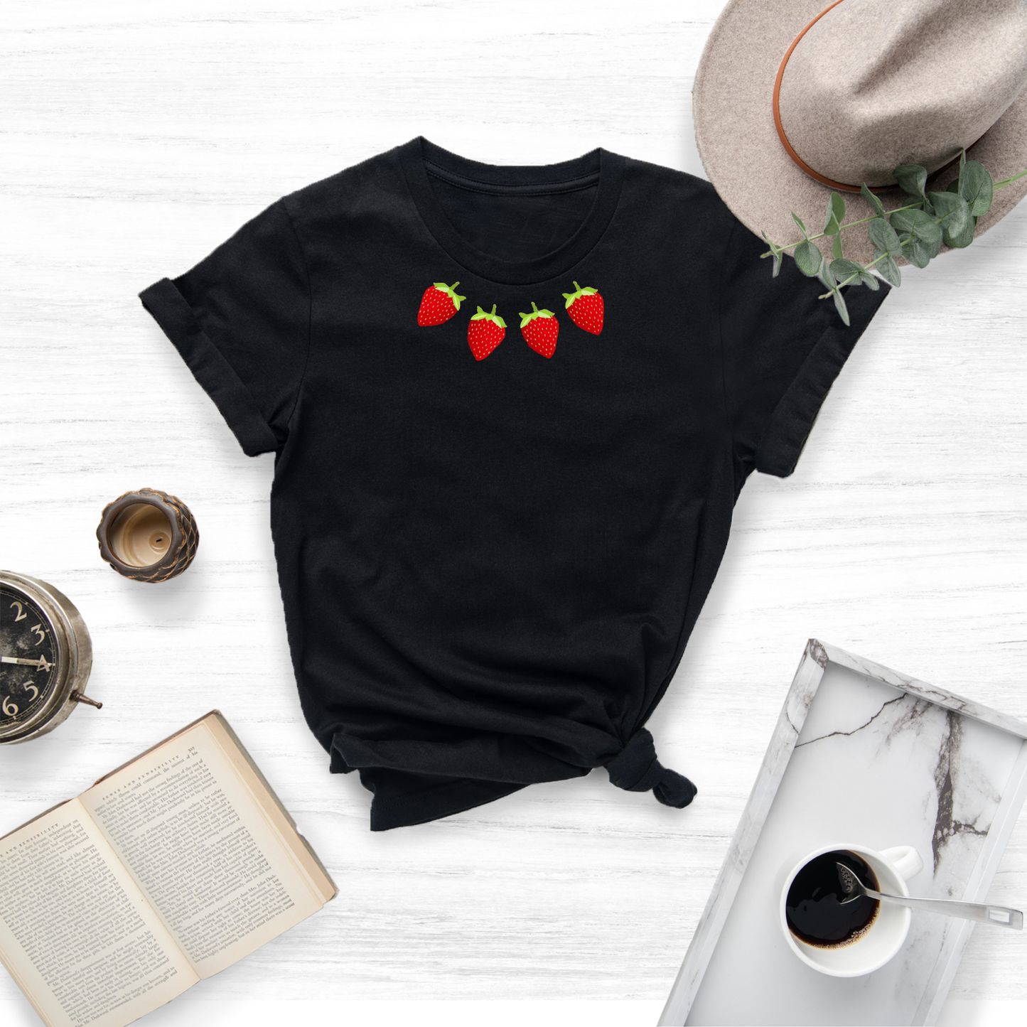 This unique tee features a vibrant embroidered strawberry design, adding a touch of sweetness to your wardrobe.