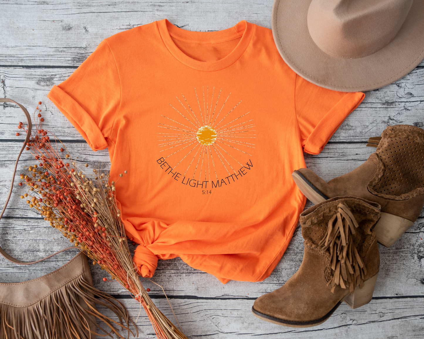 Spread positivity and hope with this unique and eye-catching "Be The Light" t-shirt.